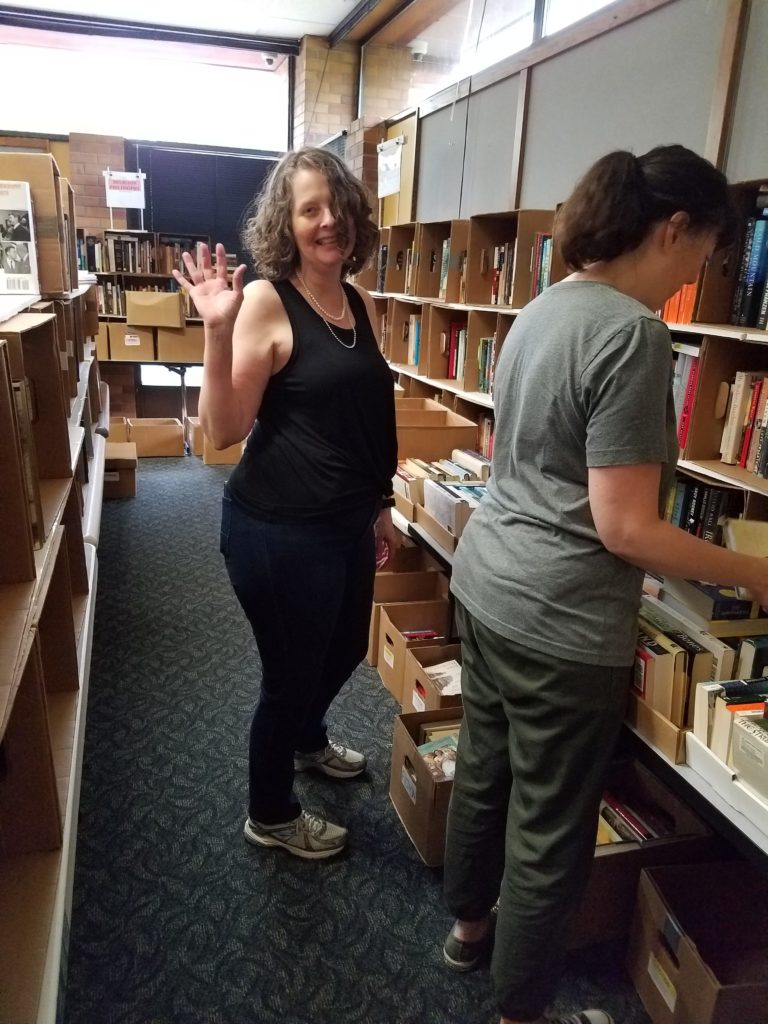 Lug, stack, repeat. That's the book sale volunteer mantra. (Pat Harper photo)